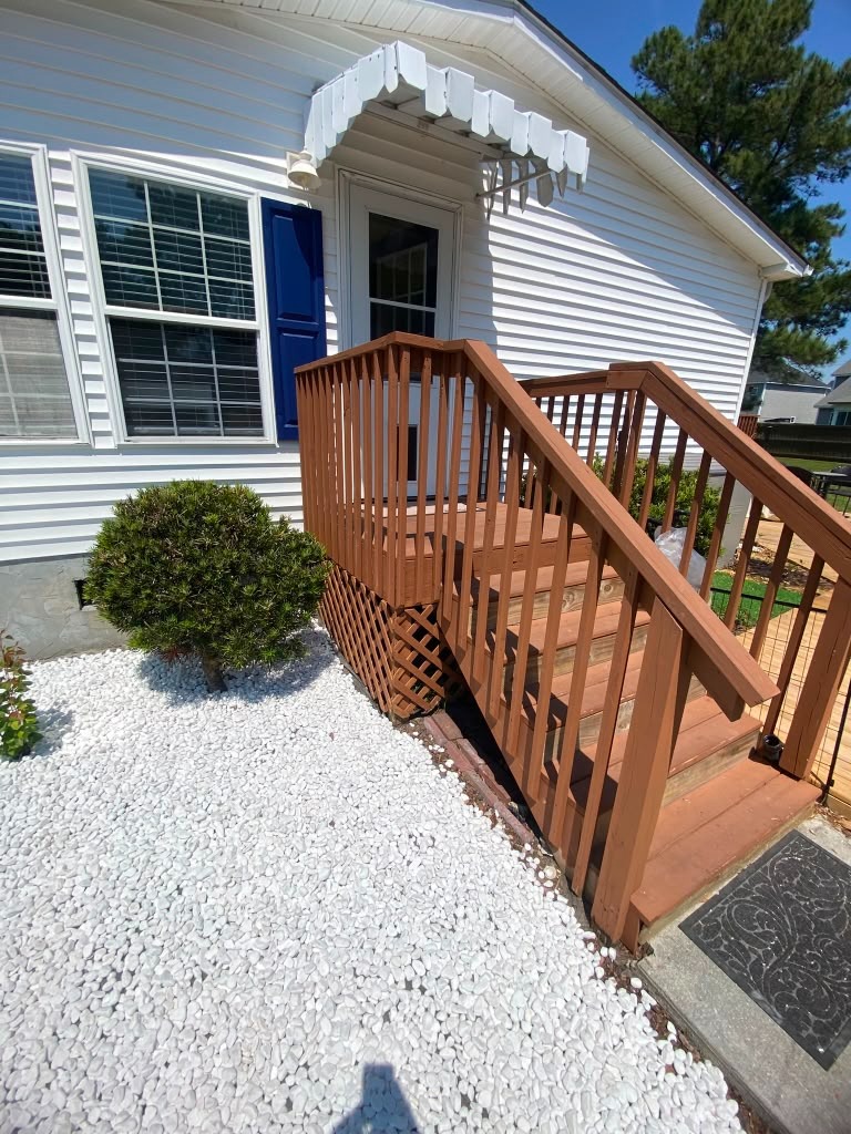 Original front entry steps and brown railing before the Handysam renovation